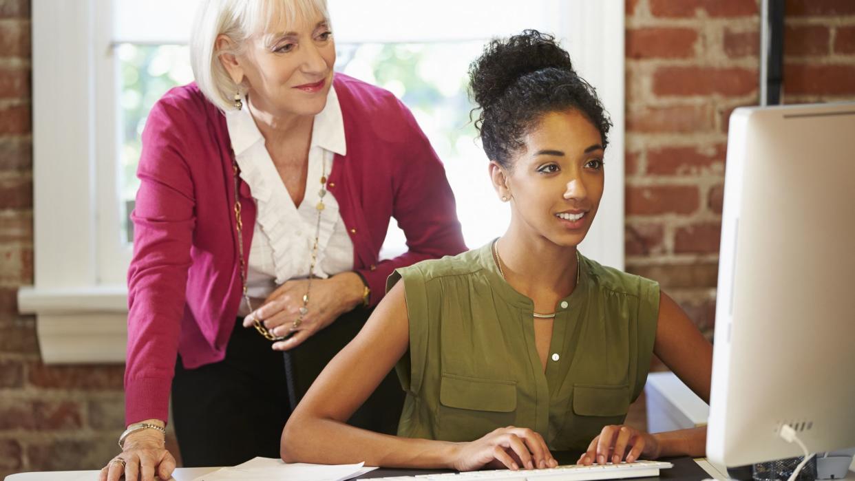 Two Women Working At Computer.