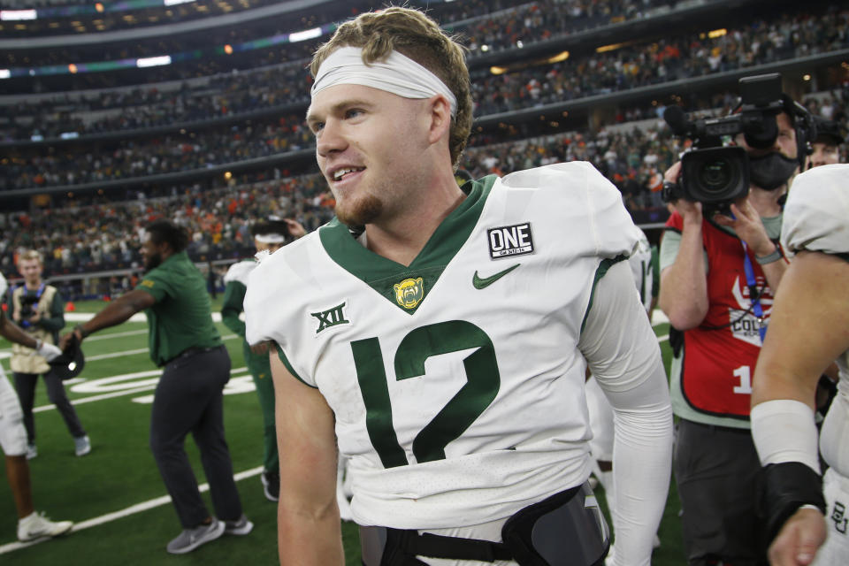 Baylor quarterback Blake Shapen (12) celebrates on the field after they defeated Oklahoma State in an NCAA college football game for the Big 12 Conference championship in Arlington, Texas, Saturday, Dec. 4, 2021. (AP Photo/Tim Heitman)