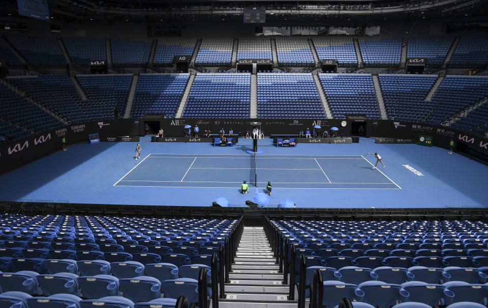 Karolina Muchova of the Czech Republic and compatriot Karolina Pliskova play in an empty Rod Laver Arena during their third round match at the Australian Open tennis championship in Melbourne, Australia, Saturday, Feb. 13, 2021. The Australian Open continues but without crowds after the Victoria state government imposed a five-day lockdown starting Saturday in response to a COVID-19 outbreak at a quarantine hotel.(AP Photo/Andy Brownbill)