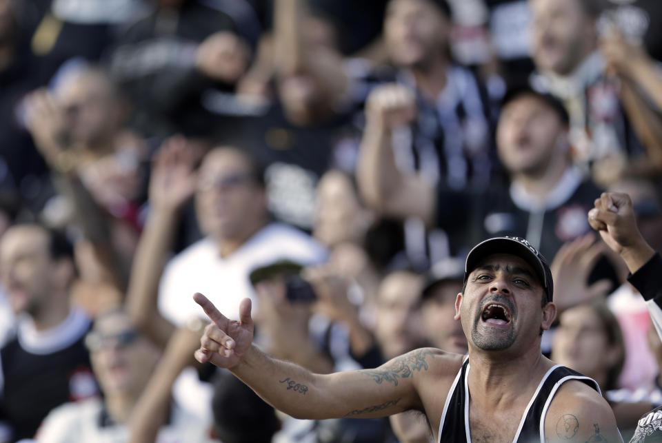 Corinthians' supporters cheer during a Brazilian soccer league match against Flamengo in Sao Paulo, Brazil, Sunday, April 27, 2014. (AP Photo/Andre Penner)