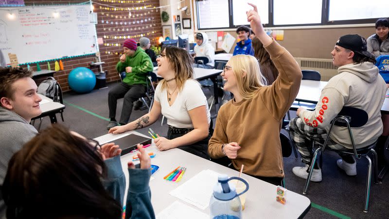 Tori Poulsen, 18, center, and Lily Williams, 17, right, laugh during a review game being played in their English class at Cyprus High School in Magna on Friday, Jan. 27, 2023.