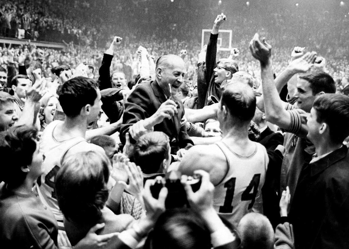 Everett Case, center, is lifted aloft by players and fans following the Wolfpack’s 1965 ACC Tournament title win.