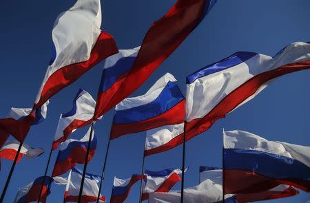 Russian and Crimean flags flutter in the wind during celebrations marking the first anniversary of Russia's annexation of Ukraine's Black Sea peninsula of Crimea, in central Simferopol March 16, 2015. REUTERS/Maxim Shemetov