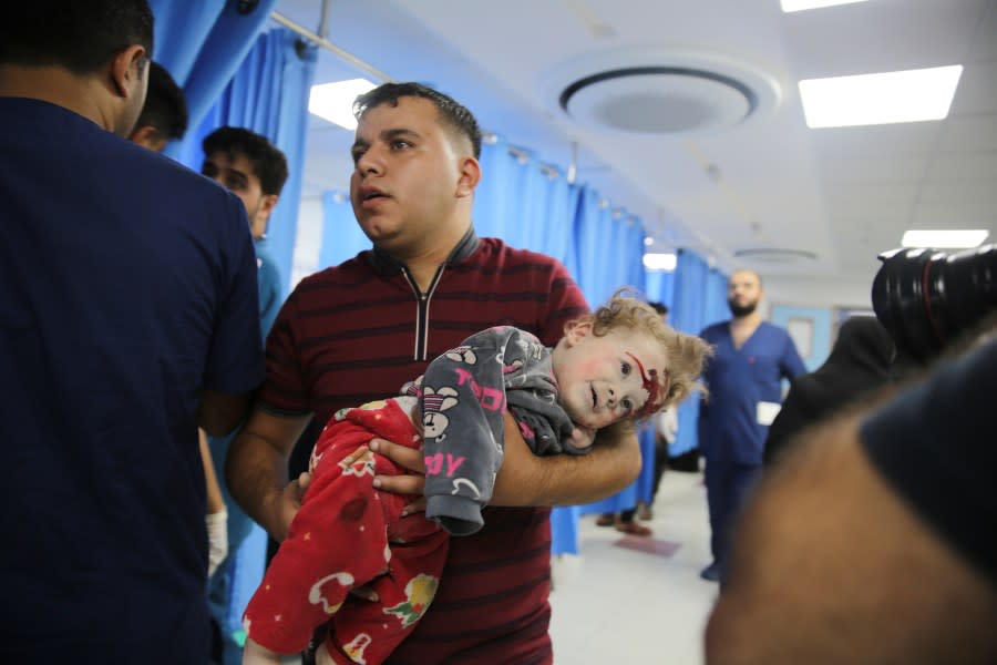 A Palestinian child wounded in Israeli strikes is brought to Shifa Hospital in Gaza City on Wednesday, Oct. 11, 2023. (AP Photo/Ali Mahmoud)