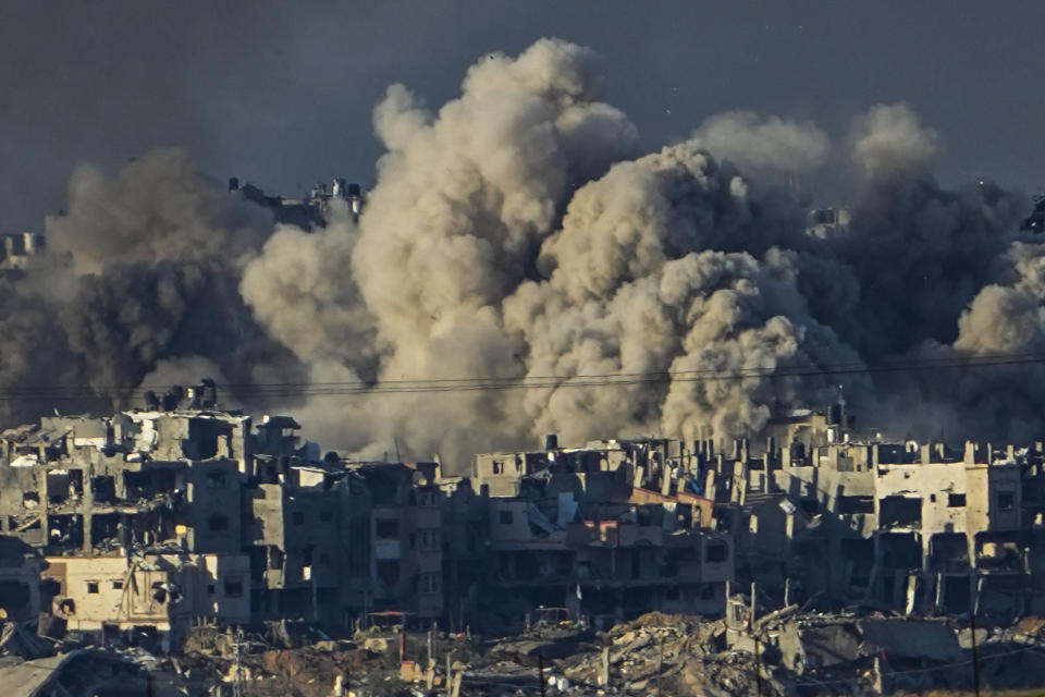 FILE - Smoke rises following an Israeli bombardment in the Gaza Strip, as seen from southern Israel, Saturday, Dec. 16, 2023. Israel is sending top legal minds, including a Holocaust survivor, to The Hague this week to counter allegations that it is committing genocide against Palestinians in Gaza. (AP Photo/Ariel Schalit, File)