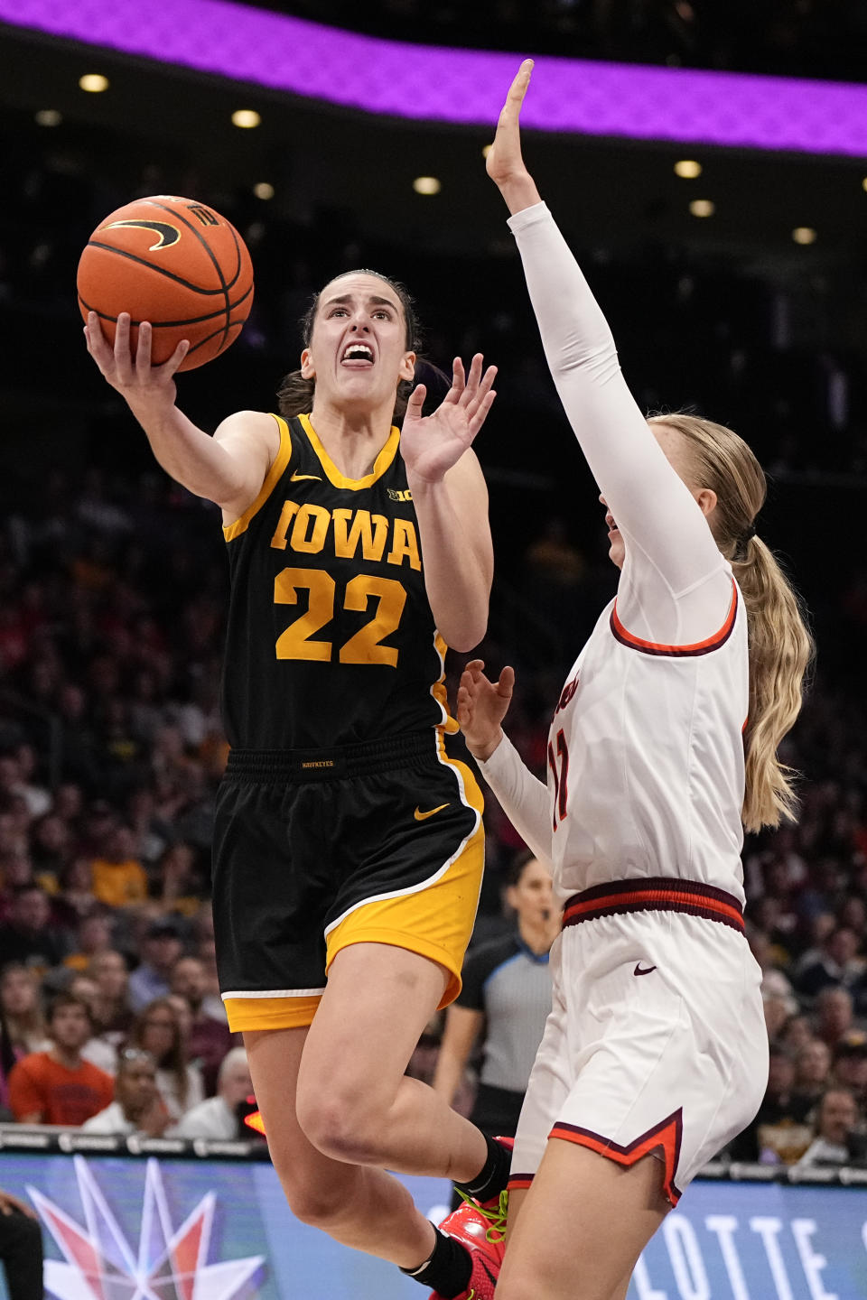 Iowa guard Caitlin Clark, left, shoots over Virginia Tech guard Matilda Ekh during the first half of an NCAA women's college basketball game Thursday, Nov. 9, 2023, in Charlotte, N.C. (AP Photo/Chris Carlson)