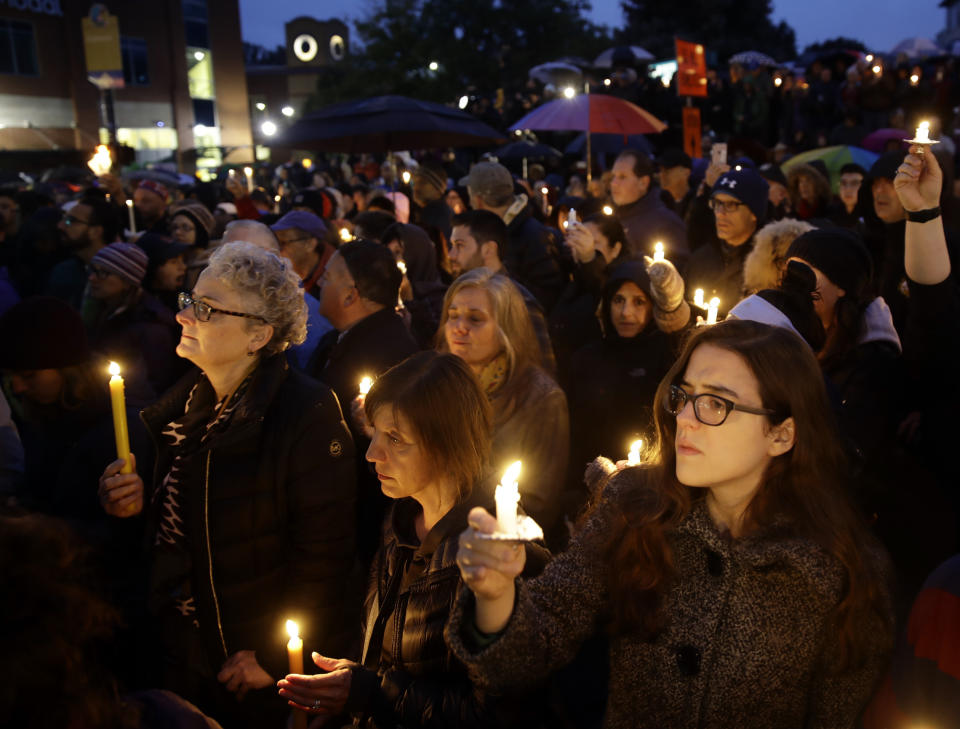 People hold candles as they gather for a vigil in the aftermath of a deadly shooting at the Tree of Life Congregation, in the Squirrel Hill neighborhood of Pittsburgh, Saturday, Oct. 27, 2018. (AP Photo/Matt Rourke)