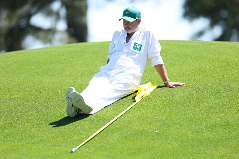 Caddie Billy Foster takes a break at No. 8 during Sunday's final round.