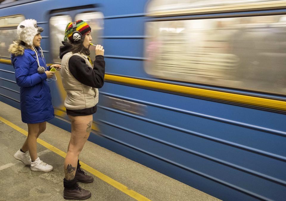 Passengers without their pants wait on a underground platform during the "No Pants Subway Ride" in Kiev