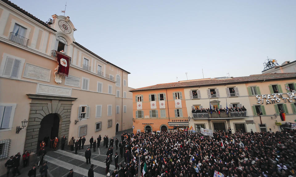 FILE - Pope Benedict XVI greets faithful from his summer residence of Castel Gandolfo, the scenic town where he spent his first post-Vatican days and made his last public blessing as pope, Feb. 28, 2013. Pope Emeritus Benedict XVI's death has hit Castel Gandolfo's "castellani" particularly hard, since many knew him personally, and in some ways had already bid him an emotional farewell when he uttered his final words as pope from the palace balcony overlooking the town square. (AP Photo/Alessandra Tarantino, File)