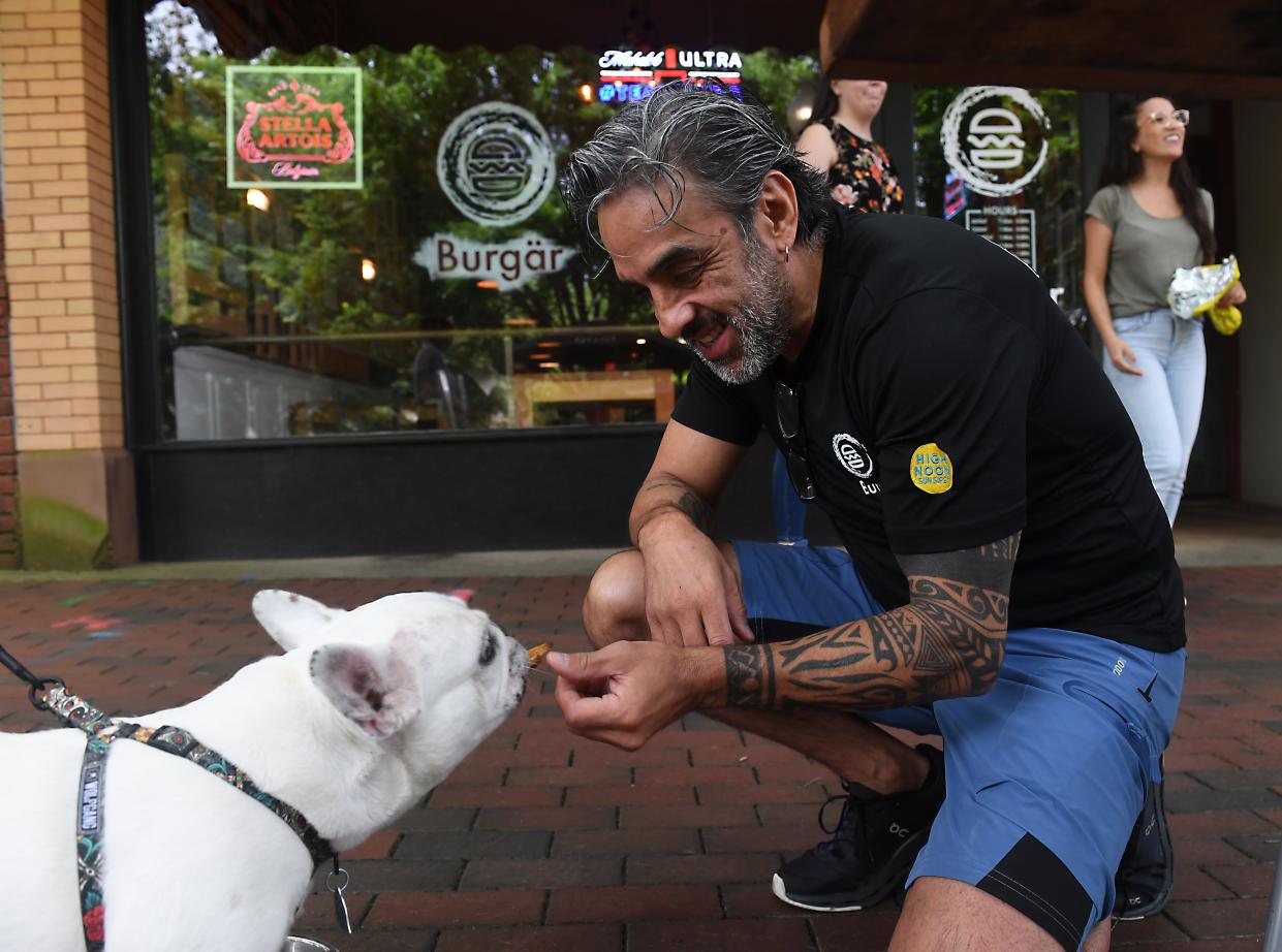 Many restaurants in downtown Spartanburg are pet friendly. 
Alejandro Morales partner and manager of Burgar, a restaurant in downtown Spartanburg, welcomes a dog named Penny to the outdoor seating at the restaurant on Friday, May 10, 2024.