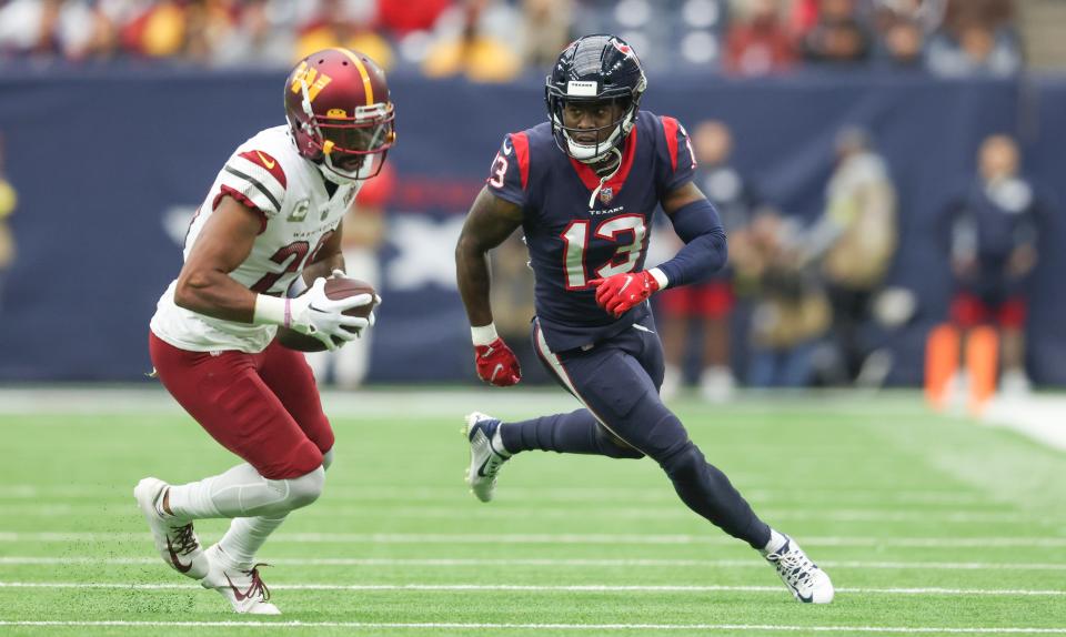 Cornerback Kendall Fuller returns an interception for a touchdown against Houston and Brandin Cooks in 2022.