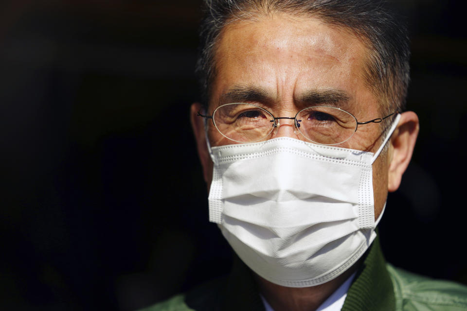 Yasuo Takamatsu speaks with The Associated Press at Onagawa, Miyagi prefecture, northern Japan on Monday, March 8, 2021. Takamatsu, 64, lost his wife, Yuko, when a tsunami hit Onagawa, on March 11, 2011, in Miyagi prefecture. He has been looking for her ever since. He even got his diving license to try to find her remains, and for seven years he has gone on weekly dives. (AP Photo/Eugene Hoshiko)