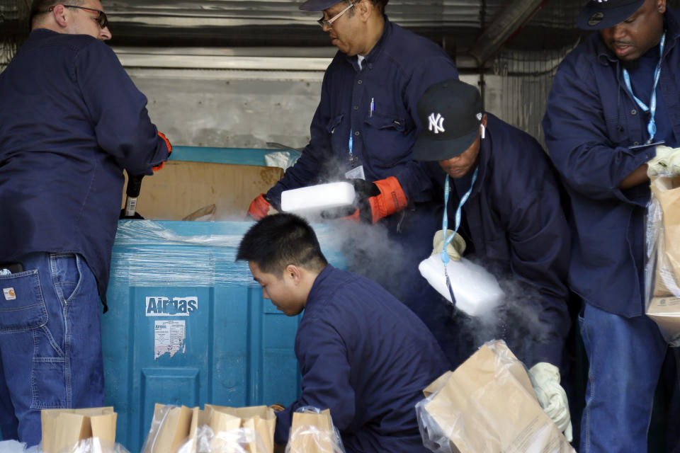 Workers load dry ice into bags inside of a Con Edison truck for customers without power in the Brooklyn borough of New York, Monday, July 22, 2019. Mayor Bill de Blasio called for an investigation Monday of power outages that came at the end of this weekend's oppressive heat, saying he no longer trusts utility Con Edison after it decided to turn off power to thousands of customers. (AP Photo/Seth Wenig)