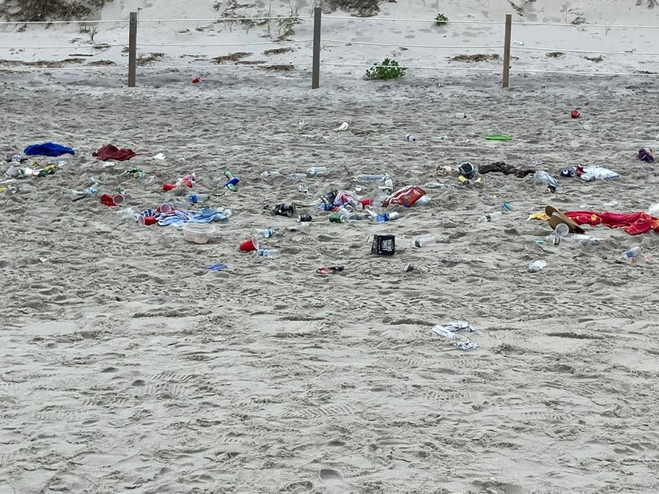 Trash left behind on July 4, 2023 on a beach in Dennis, Massachusetts. There will be no daily parking passes sold at Mayflower, Chapin, and Bayview beaches on the holiday this year, police say (Dennis Police Dept)