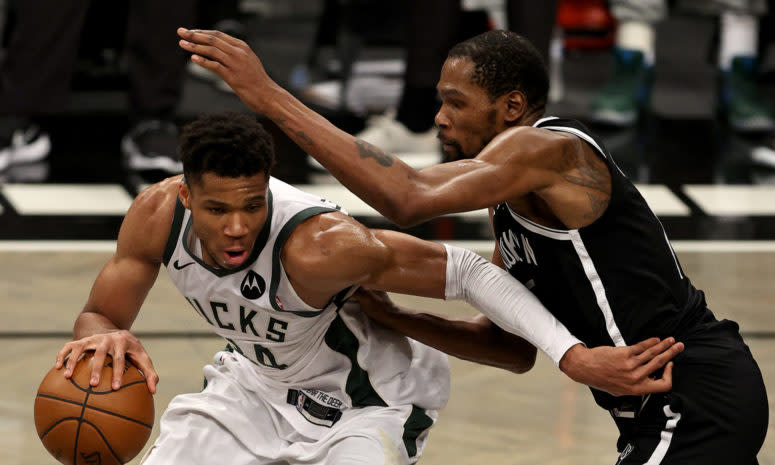 Nets star Kevin Durant guards Bucks star Giannis Antetokounmpo.