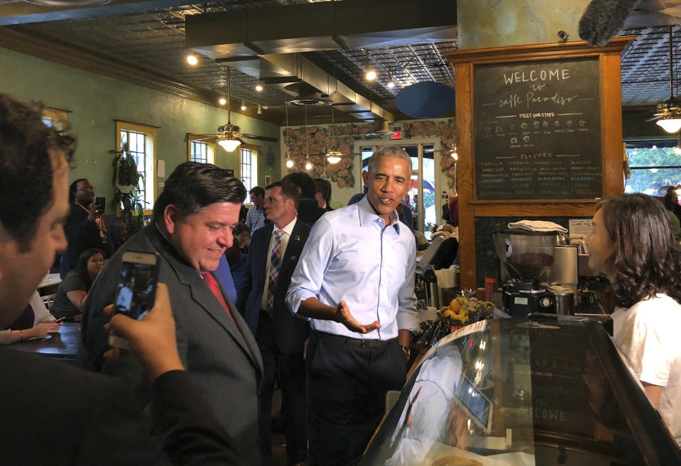 Former President Barack Obama makes a campaign stop at Caffe Paradiso in Urbana, Ill., Friday, Sept. 7, 2018, where he did a campaign stop with Illinois Democratic gubernatorial candidate J.B. Pritzker, left, following his speech at the University of Illinois. (AP Photo/Sara Burnett)