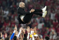 Morocco's head coach Walid Regragui is thrown in the air by his players after winning the World Cup group F soccer match between Canada and Morocco at the Al Thumama Stadium in Doha , Qatar, Thursday, Dec. 1, 2022. (AP Photo/Natacha Pisarenko)