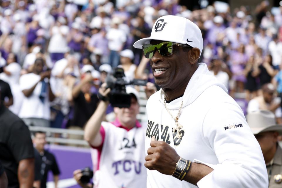 Colorado Buffaloes head coach Deion Sanders runs on the field before the game against the TCU Horned Frogs at Amon G. Carter Stadium in Fort Worth on Sept. 2, 2023.