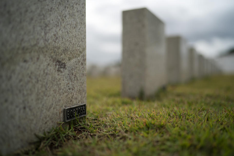 In this Aug. 5, 2019 photo a number identifies the headstone of 11-year-old Kaua Rozario at a cemetery in Rio de Janeiro, Brazil. Kaua's father said his son was riding his bicycle in the Vila Alianca slum when he happened across a police pursuit of drug suspects and was hit by a stray bullet. Five days later, he died. (AP Photo/Leo Correa)