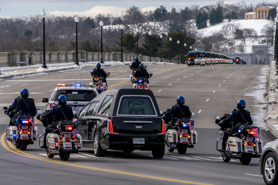 A hearse carrying the remains of U.S. Capitol Police officer Brian Sicknick makes its way to Arlington National Cemetery after Sicknick was lying in honor at the U.S Capitol, Wednesday, Feb. 3, 2021, in Washington. (AP Photo/Andrew Harnik)