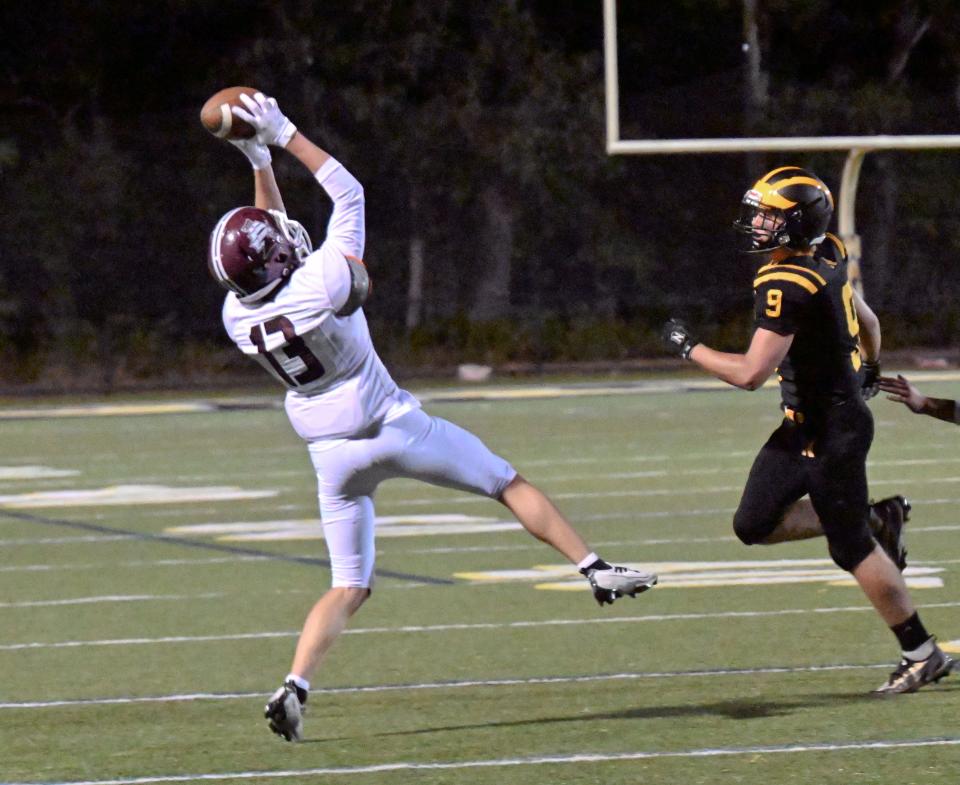 NORTH EASTHAM   09/30/22  Evan Hauptmann of Falmouth intercepts a pass meant for Owen White of Nauset.    football