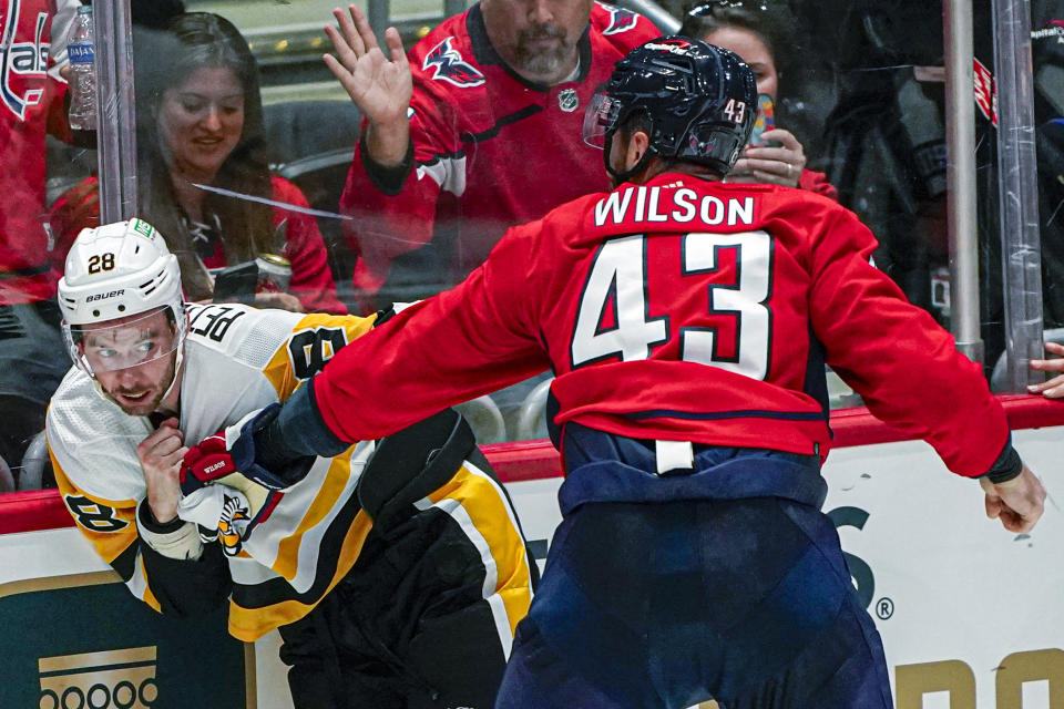 Washington Capitals right wing Tom Wilson (43) fights with Pittsburgh Penguins defenseman Marcus Pettersson (28) during the third period of an NHL hockey game Friday, Oct. 13, 2023, in Washington. The Penguins won 4-0. (AP Photo/Andrew Harnik)