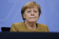 German Chancellor Angela Merkel pauses as she addresses a press conference following talks via video conference with Germany's state governors on extending coronavirus restrictions at the Chancellery in Berlin, Wednesday, Nov. 25, 2020. Merkel and the country’s 16 state governors have agreed to extend a partial shutdown well into December in an effort to further reduce the rate of coronavirus infections ahead of the Christmas period. Germany embarked on a so-called “wave-breaker” shutdown on Nov. 2, initially slated to last four weeks. (Odd Andersen/Pool Photo via AP)