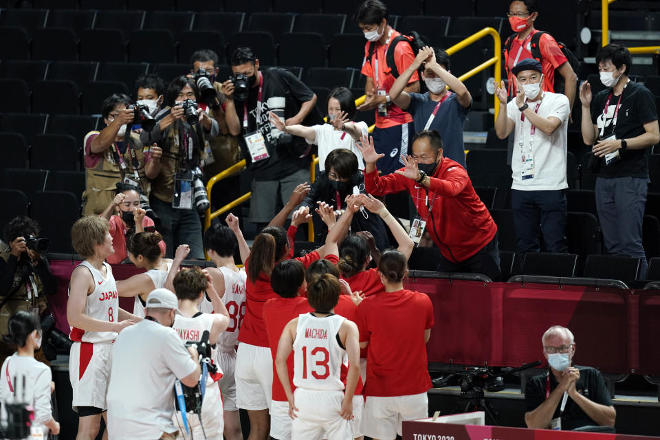 Japan players celebrate with fans after a women's basketball quarterfinal round game against Belgium at the 2020 Summer Olympics, Wednesday, Aug. 4, 2021, in Saitama, Japan. (AP Photo/Charlie Neibergall)