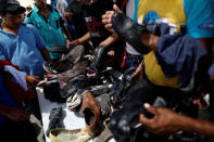 Central American migrants, moving in a caravan through Mexico, receive shoes at a temporary shelter, in Hermosillo, Sonora state, Mexico April 23, 2018. REUTERS/Edgard Garrido