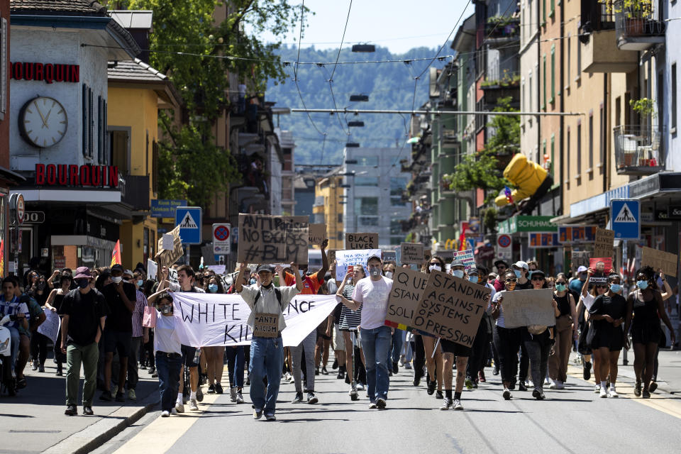 Demonstranten halten bei einem Protest Plakate und ein Banner hoch. Der Protest richtet sich gegen den gewaltsamen Tod des Afroamerikaners George Floyd in den USA durch einen weißen Polizisten in Minneapolis. Foto: Alexandra Wey / KEYSTONE / dpa