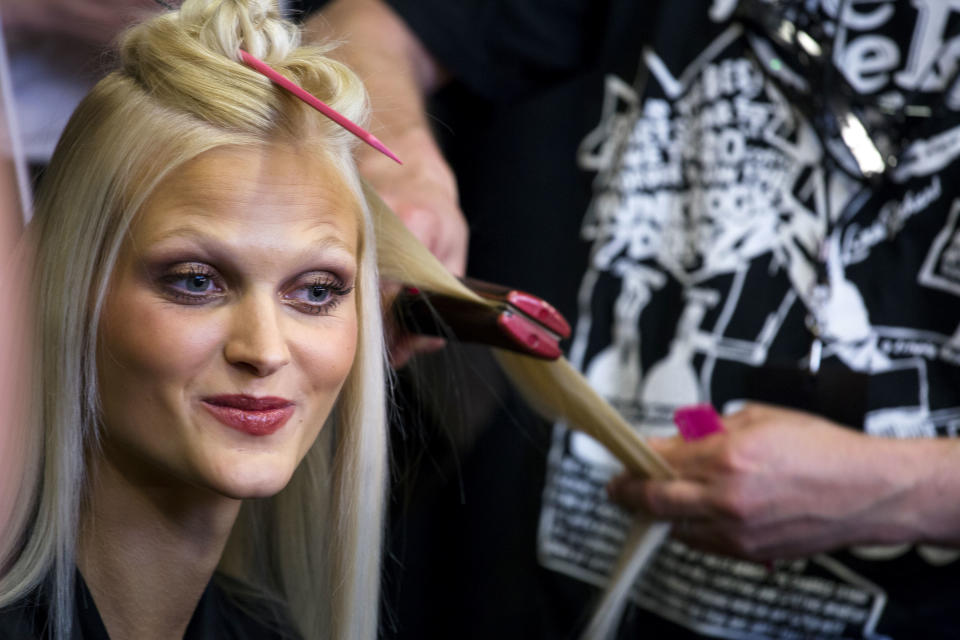 Model Charlotte Hoyer of Denmark prepares before the Donna Karan Spring 2014 collection is modeled during Fashion Week in New York, Monday, Sept. 9, 2013. (AP Photo/Craig Ruttle)