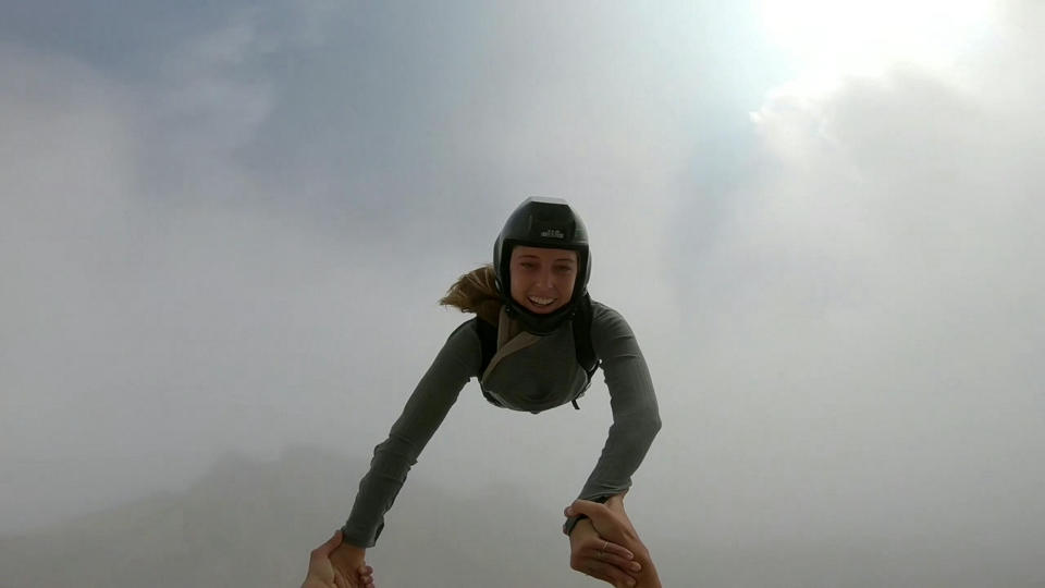 These friends filmed themselves freefalling backwards from a cliff - while holding hands. Josephine Eve, 28, and Niclas Strohmeier, 23, performed the stunt at the BASE jumping hotspot of Monte Brento, Italy. They fall backwards into the dense mist below before separating in the air and landing safely.