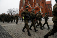 Town hall clerk Monika Pawlik, 24, marches at a parade after being sworn in as a territorial soldier in Bialystok, Poland, December 16, 2017. REUTERS/Kacper Pempel/Files