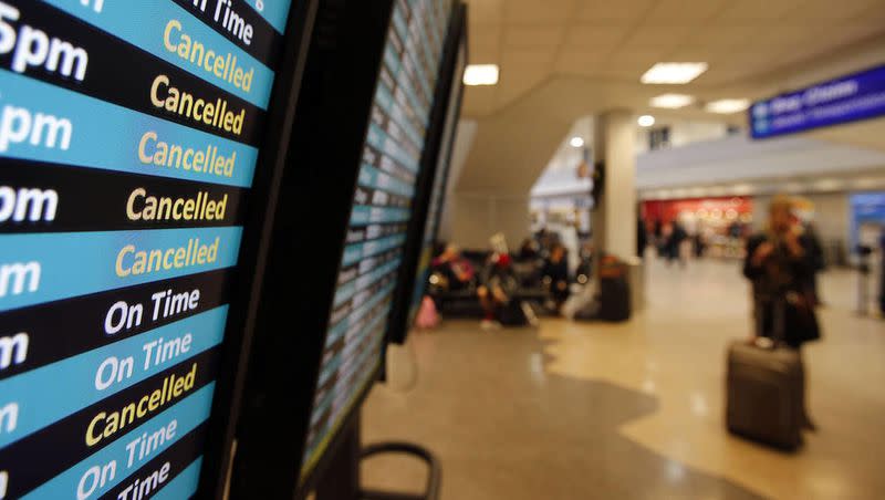 Signs at Salt Lake City International Airport show canceled flights due to a snowstorm on Dec. 19, 2013.