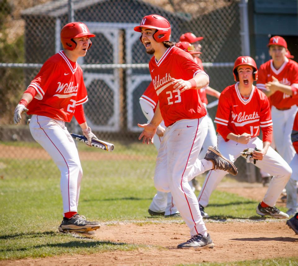 NFA senior Ethan Heinsz (23) and his teammates celebrate after scoring a run. The Wildcats begin play in the ECC tournament on Tuesday.