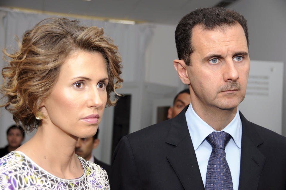 FILE - In this July, 13, 2010 file photo, Syrian President Bashar Assad, left, and his wife Asma Assad, listen to explanations as they visit a technology plant in Tunis, Tunisia. Assad’s office said Wednesday, March 17, 2021, the country's first couple are on their way to recovery nine days after they tested positive for coronavirus. The presidency said that Assad and his wife have had mild symptoms of the illness and are continuing their work as usual from home and will return to normal life once they test negative to COVID-19 (AP Photo/Hassene Dridi, File)
