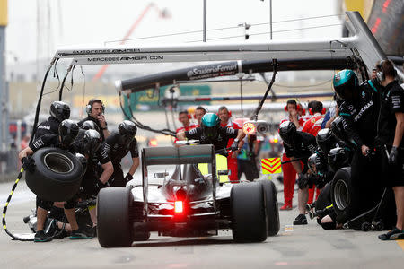 Mercedes Formula One driver Lewis Hamilton of Britain returns to the pitlane during the second practice session. REUTERS/Aly Song