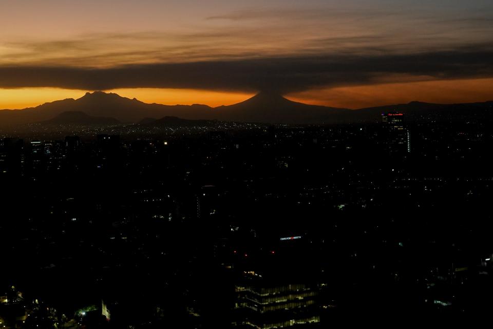 Popocatepetl volcano, right, emits smoke and ash, next to the dormant Iztaccíhuatl volcano, left, seen from Mexico City at sunrise on Tuesday, Feb. 27, 2024. The volcano known as "Don Goyo" has been active since 1994.