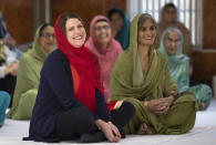 Britain's opposition Liberal Democrats party leader Jo Swinson, left, reacts during a visit to the Gurdwara Singh Sabha Temple during an election campaign stop in Glasgow, Scotland, Thursday Nov. 14, 2019. Britain's Brexit is one of the main issues for voters and political parties as the UK goes to the polls in a General Election on Dec. 12. (Jane Barlow/PA via AP)