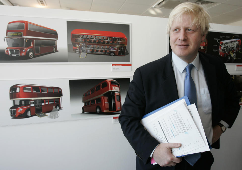 London's Mayor Boris Johnson stands next to some of the winning designs that will lead to the next generation of the London's famous red Routemaster bus, at an award ceremony in London Friday, Dec. 19, 2008. It is  hoped that the new bus which will incorporate the best of the winning designs will be on London streets in late 2011.(AP Photo/Alastair Grant)