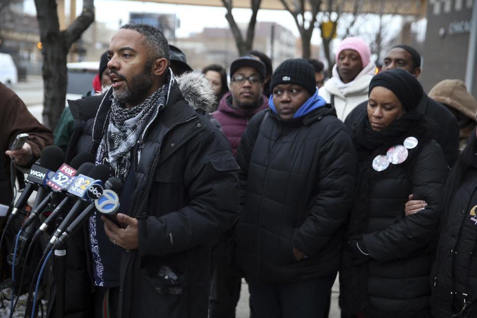 Kofi Ademola, left, of the group Black Lives Matter Chicago, and other protesters talk to the media outside the Chicago Police District 1 headquarters on South State Street in Chicago on Friday, Jan. 13, 2017. Speakers were critical of the mayor and the police department and said Chicagoans already knew from experience what the Department of Justice said in its report critical of the Chicago Police department. (Terrence Antonio James/Chicago Tribune via AP)