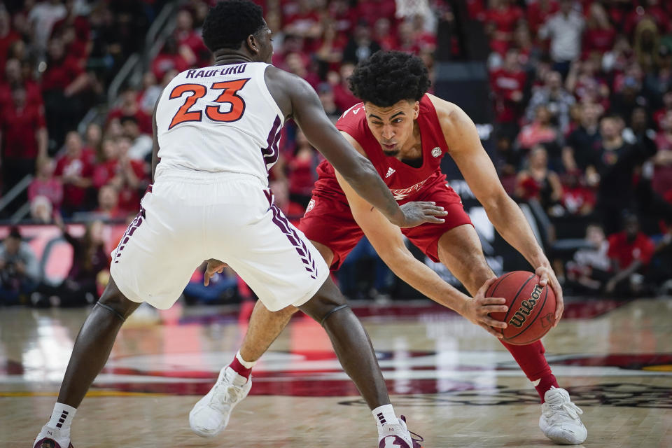 Louisville forward Jordan Nwora (33) plays against Virginia Tech guard Tyrece Radford (23) during the second half of an NCAA college basketball game, Sunday, March 1, 2020 in Louisville, Ky. (AP Photo/Bryan Woolston)