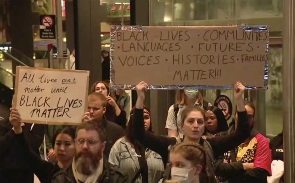 In this image made from video, protesters hold up placards reading "Black Lives Matter" during a peaceful rally in Perth, Australia, Monday, June 1, 2020. Hundreds of demonstrators gathered to protest the death of George Floyd, a black man, who died after being restrained by Minneapolis police officers on May 25. (Channel 10 via AP)