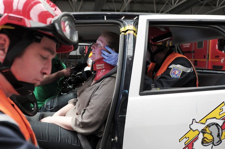 Firefighters keep a person under hypnosis during an extrication exercise in Haguenau, France on May 28, 2013. Staff trained in hypnosis establish a more personal link with the victim and divert his attention away from the trauma of the scene