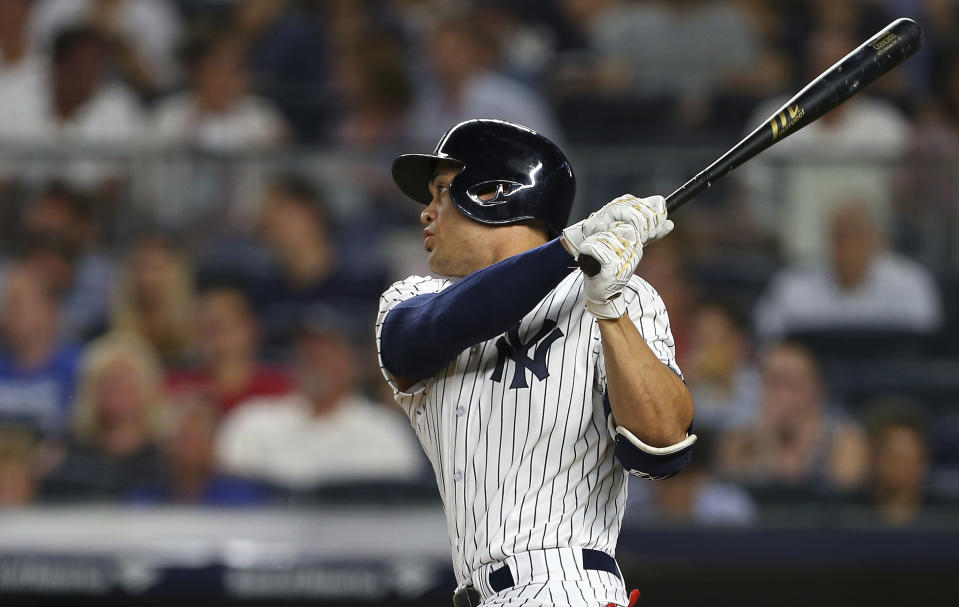 New York Yankees' Giancarlo Stanton watches his two-run home run during the third inning against the Detroit Tigers during a baseball game Thursday, Aug. 30, 2018, at Yankee Stadium in New York. It was Stanton's 300th career home run. (AP Photo/Rich Schultz)