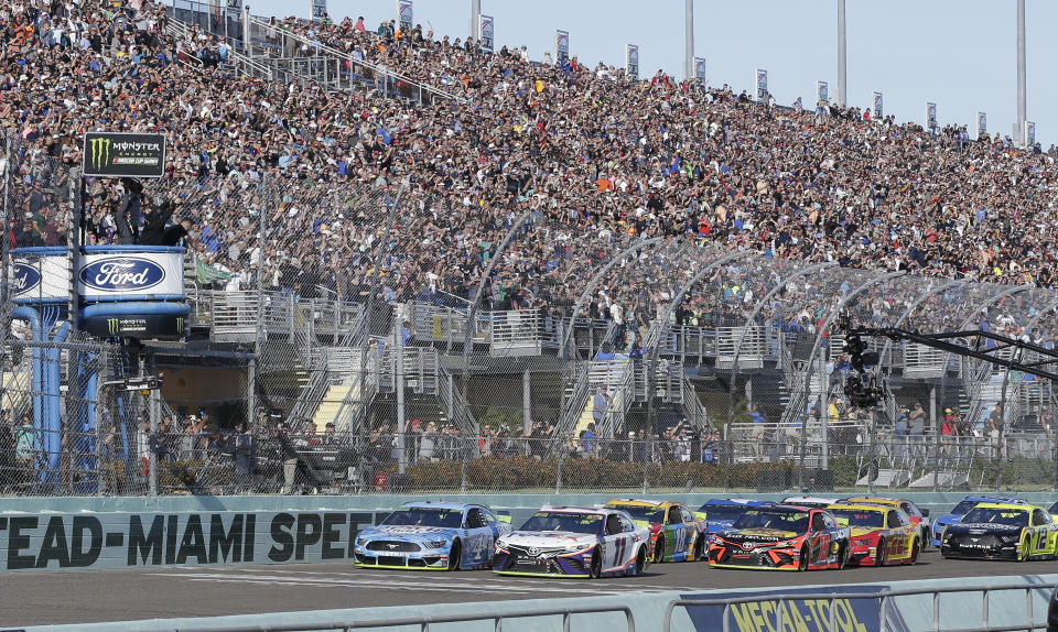 Denny Hamlin (11) leads the field to start the NASCAR Cup Series auto race on Sunday, Nov. 17, 2019, at Homestead-Miami Speedway in Homestead, Fla. (AP Photo/Terry Renna)