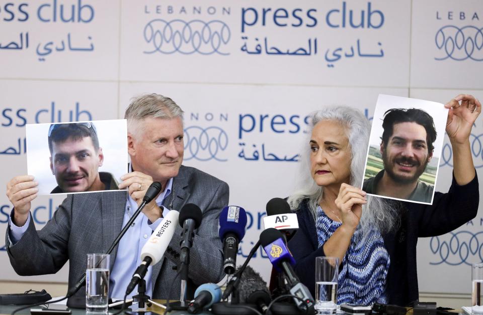 Marc and Debra Tice, parents of U.S. journalist Austin Tice who was kidnapped in Syria, hold respective dated portraits of him during a press conference in the Lebanese capital Beirut on July 20, 2017. / Credit: JOSEPH EID/AFP via Getty Images