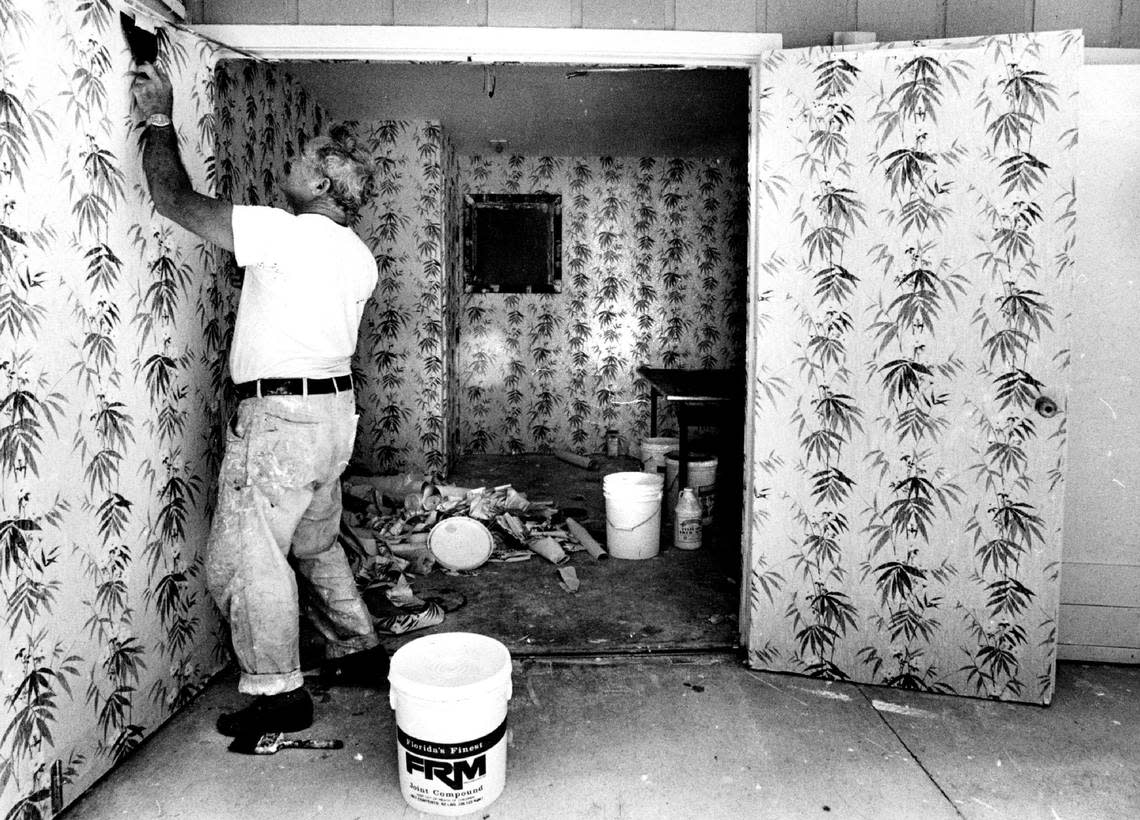 Ramon Jimenez puts up wall paper at Sheraton Key Biscayne hotel for Laurie Baum business story on renovation of hotel on Key Biscayne in 1984.