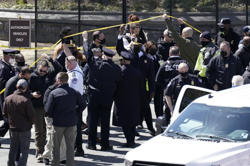 U.S. Capitol Police officers investigate near a car that crashed into a barrier on Capitol Hill